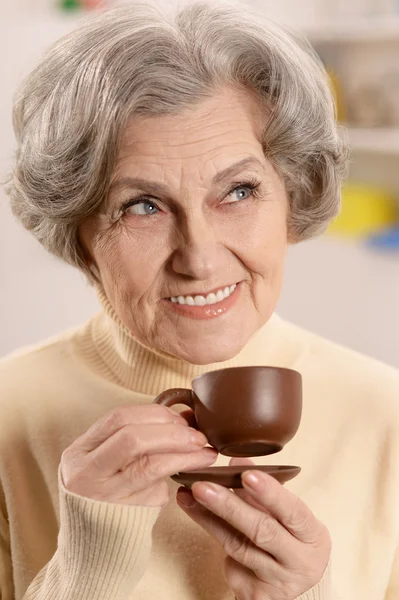 Portrait of aged woman drinking coffee — Stock Photo, Image