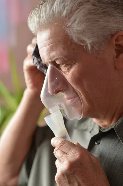 Close-up of an old man doing inhalation — Stock Photo, Image
