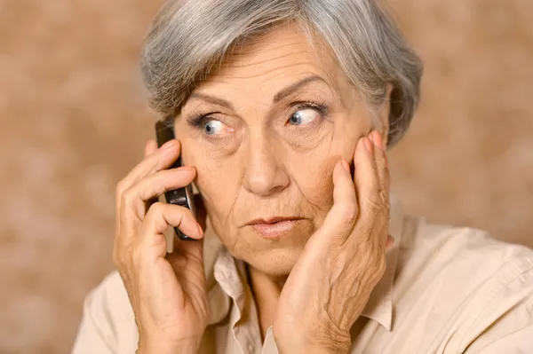 Aged woman talk on phone Stock Photo