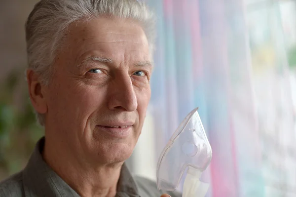 Elderly man making inhalation — Stock Photo, Image