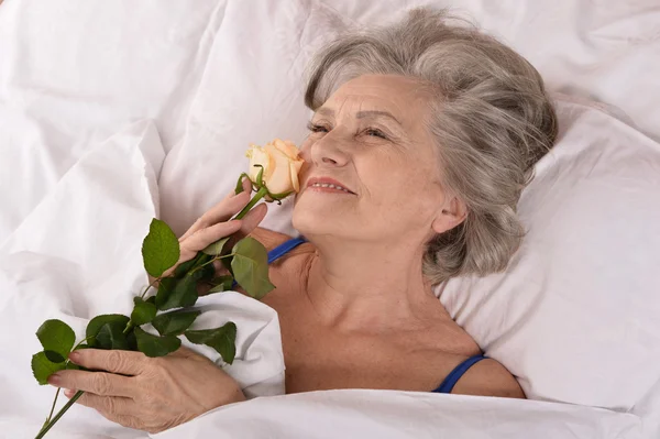 Beautiful older woman resting in the bedroom — Stock Photo, Image