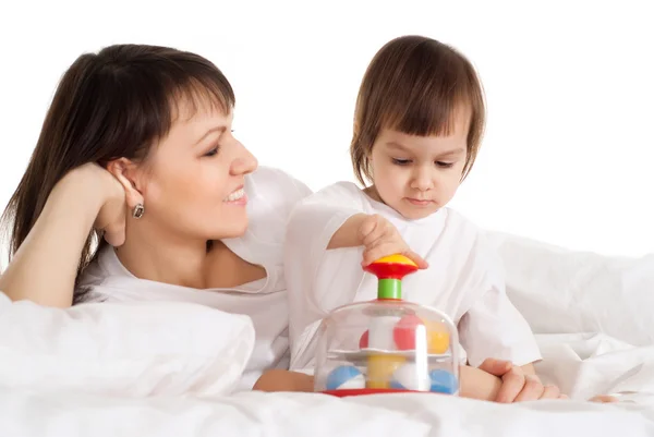 A beautiful Caucasian mother with her daughter playing with a to — Stock Photo, Image