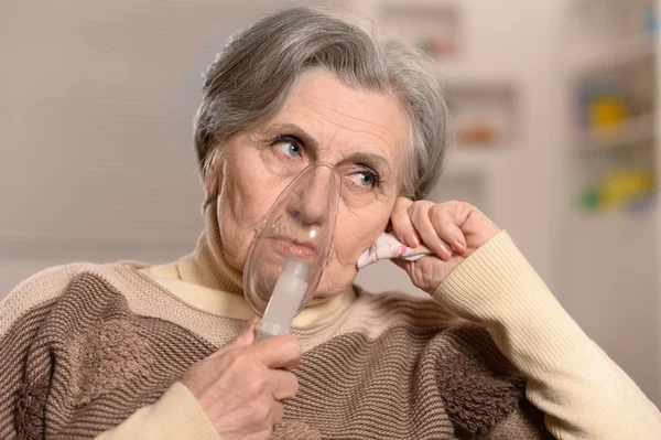 Elderly woman making inhalation — Stock Photo, Image