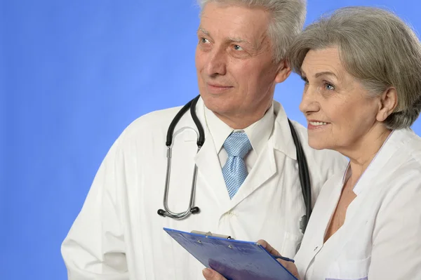 Two doctors on blue Royalty Free Stock Images