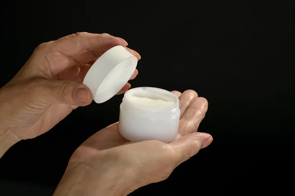 Hands holding cosmetic cream — Stock Photo, Image