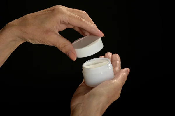 Hands holding cosmetic cream — Stock Photo, Image