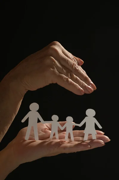Руки держат бумажную семью — стоковое фото