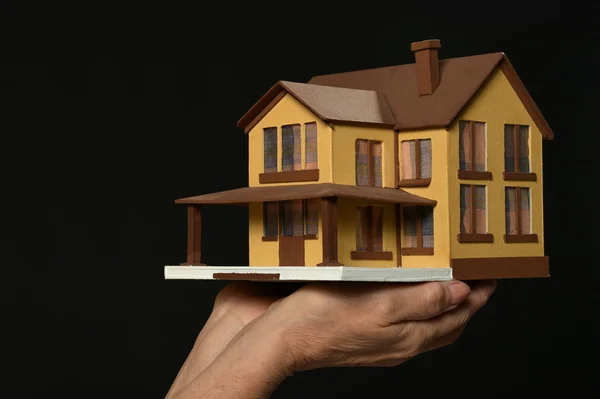 Woman hands  holding miniature house — Stock Photo, Image