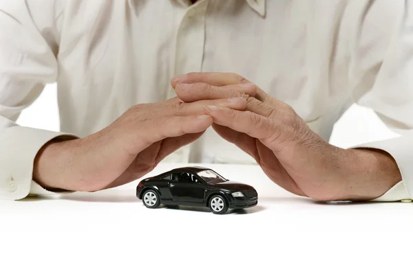 Businessman with miniature car — Stock Photo, Image