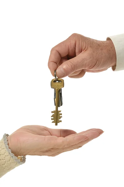 Man hands giving keys to woman — Stock Photo, Image