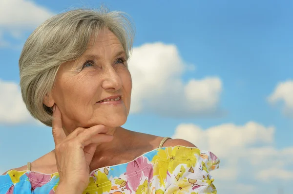 Senior woman on the background of sky — Stock Photo, Image