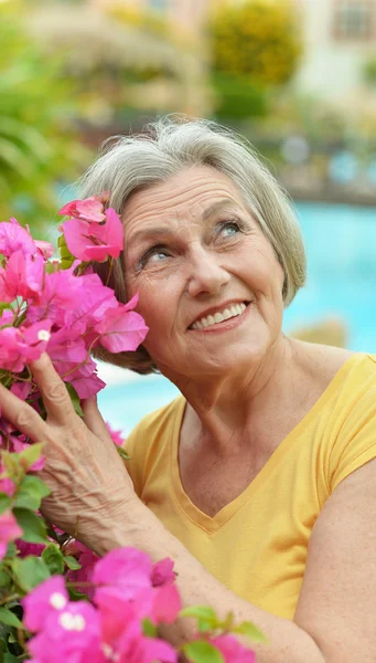 Older woman with flowers — Stock Photo, Image