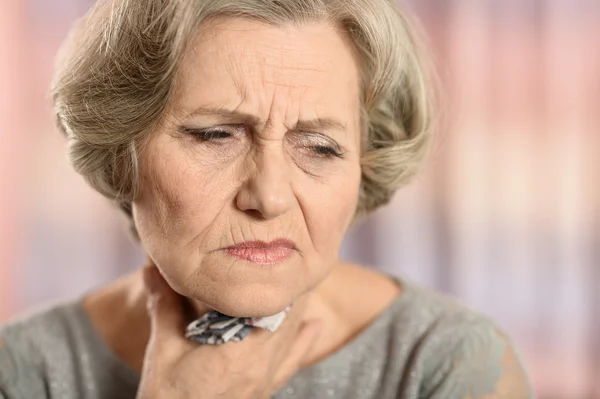Senior woman withsoar throat — Stock Photo, Image