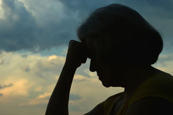 Sad senior woman silhouette — Stock Photo, Image