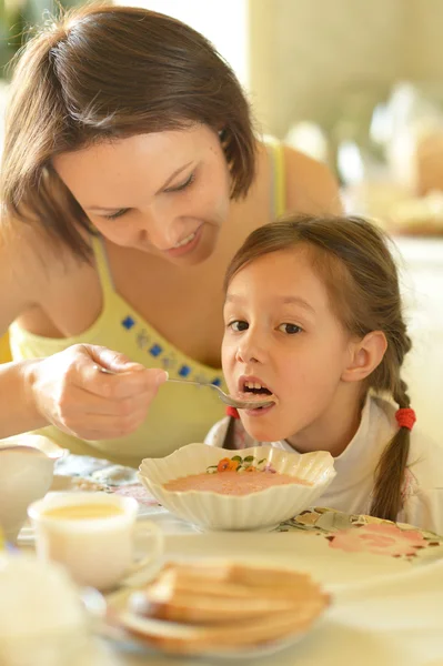 Mother and daughter eating soup Stock Photo