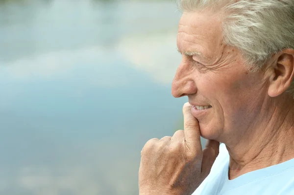 Senior man near lake — Stock Photo, Image