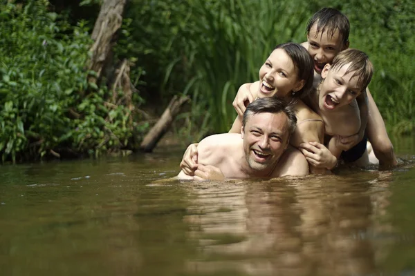 Belle famille nage dans la rivière — Photo