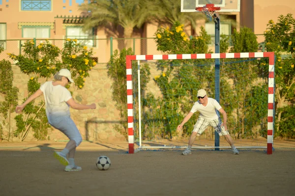 Couple actif jouant au football — Photo