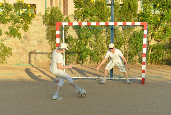 Active couple playng football — Stock Photo, Image