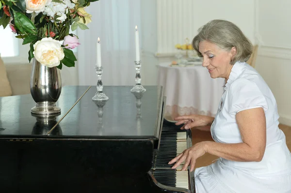 Yaşlı kadın evde piyano — Stok fotoğraf