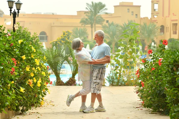 Elder couple in exotic garden — Stock Photo, Image