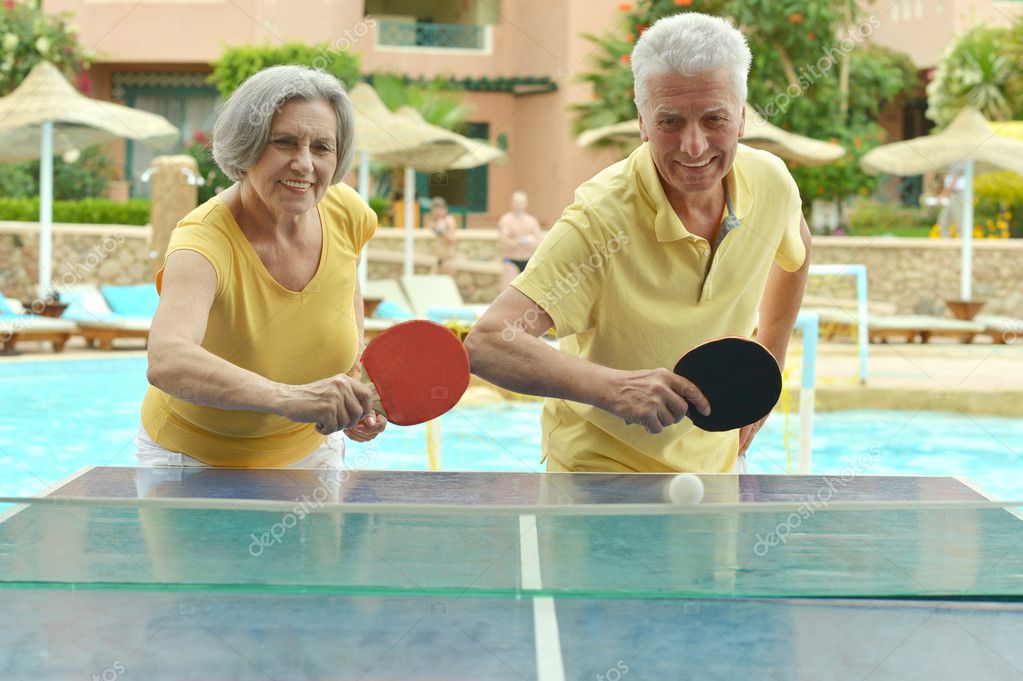Elderly couple playing ping pong — Stock Photo © aletia #49996203