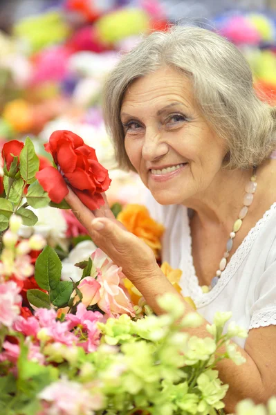 Retired woman with flowers — Stock Photo, Image