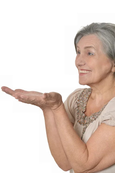 Elder woman pointing at copy space — Stock Photo, Image