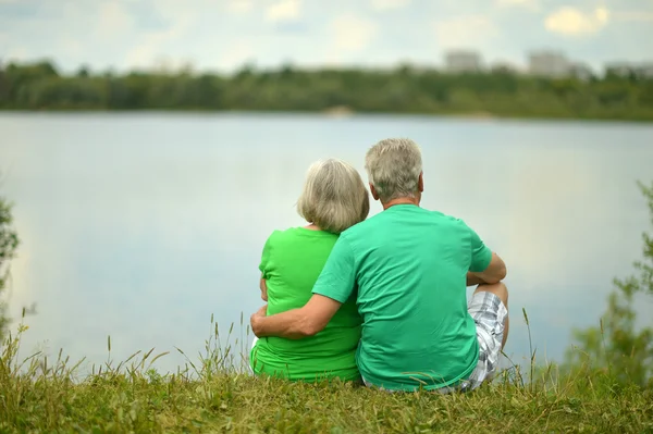 Senior couple near the river — Stock Photo, Image