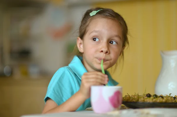 Klein meisje eten krenten — Stockfoto