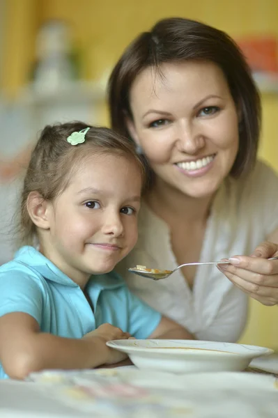 Cute mother feeding daughter — Stock Photo, Image