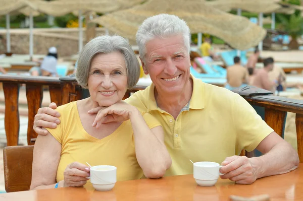 Happy beautiful older couple drink coffee together — Stock Photo, Image