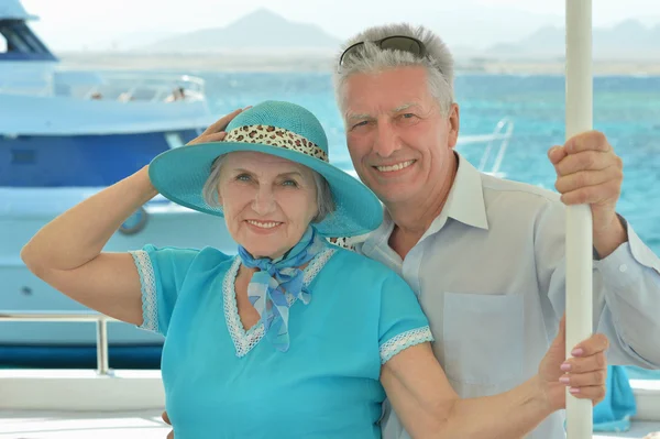 Elderly couple ride in boat on sea