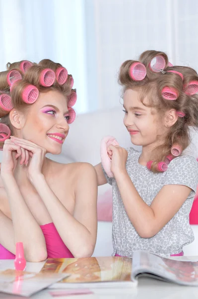 Portrait Happy Mother Little Daughter Hair Curlers Home Reading Magazine — Stock Photo, Image