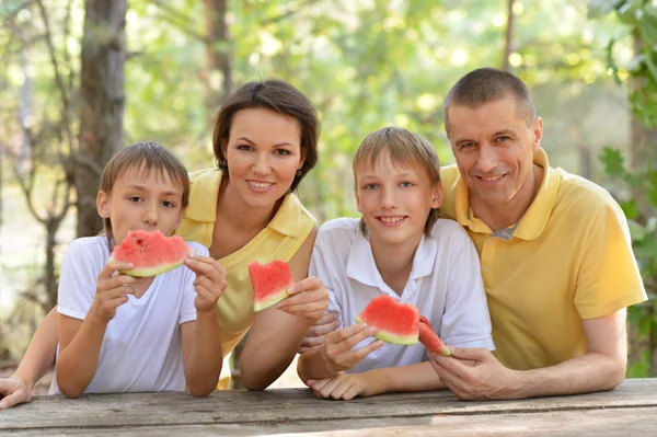 Familie isst eine Wassermelone — Stockfoto