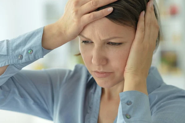 beautiful young ill woman with headache  at home