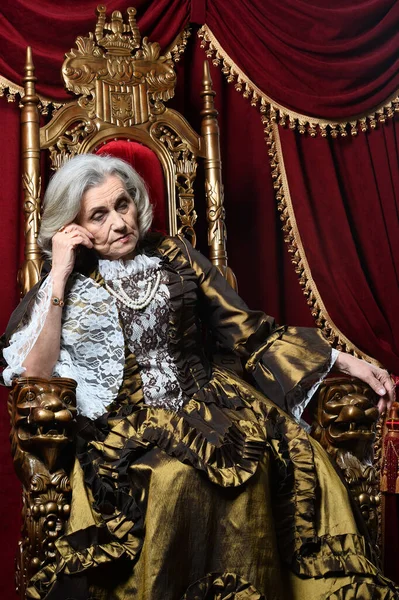 Sad Beautiful Senior Queen Throne — стоковое фото