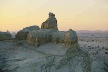 Xinjiang, china: human-shaped rock in gobi desert clipart