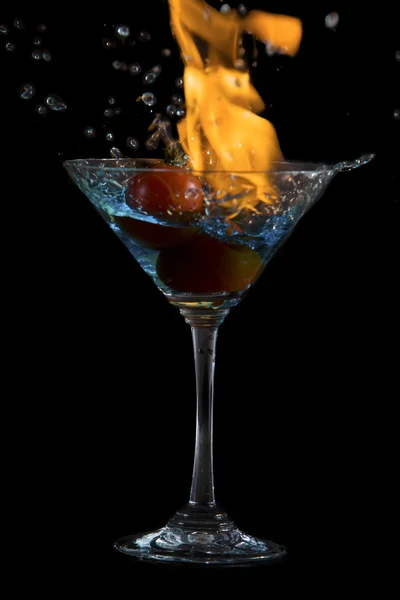 Cocktail glass with water and fire — Stock Photo, Image