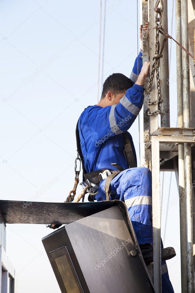 Men at work climbing rig