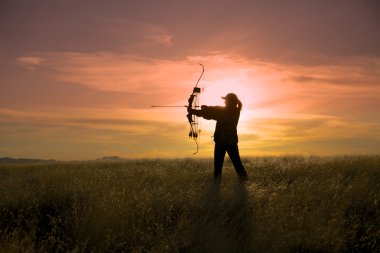 Bowhunter in Sunrise clipart