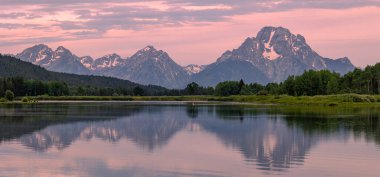 a scenic reflection landscape at sunrise in Grand Teton National Park Wyoming in summer