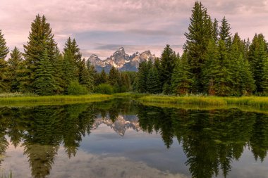 a scenic sunrise reflection landscape in summer in Grand Teton National Park Wyoming