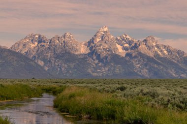 a scenic reflection landscape in the Tetons in summer