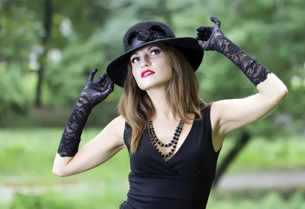 The young beautiful woman in a hat — Stock Photo, Image