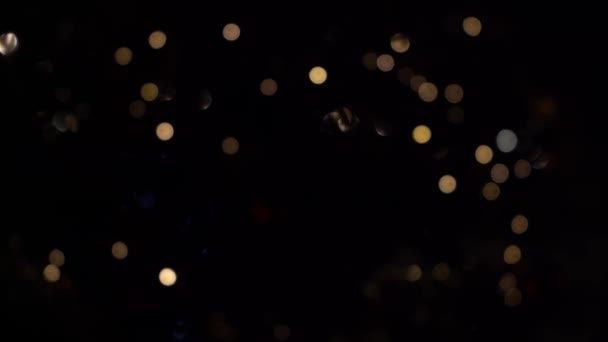 Bokeh of lights of garlands. Blurred soft focus. The garland is flashing. City lights at night. Christmas mood. — Stock video