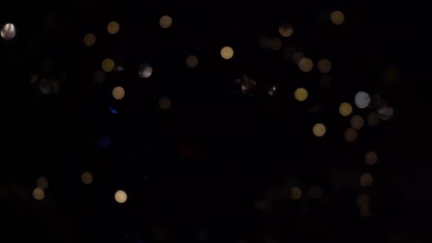Bokeh of lights of garlands. Blurred soft focus. The garland is flashing. City lights at night. Christmas mood. — Stock video