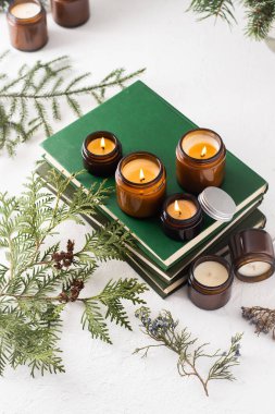 Beyaz arka planda cam kavanozlarda farklı aroma mumları. Kokulu el yapımı mum. Soya mumları kavanozda yanıyor. Balmumu ve parafin kavanozda.