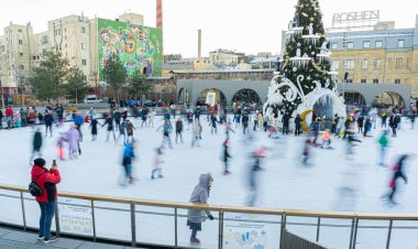 Kışın buz pateni pistinde. İnsanlar paten kayıyor. Patenler buzda kayar. Buz pateni kış sporu ve eğlencedir. Kadınlar, çocuklar, erkek bacakları....