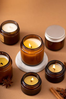 Beyaz arka planda cam kavanozlarda farklı aroma mumları. Kokulu el yapımı mum. Soya mumları kavanozda yanıyor. Balmumu ve parafin kavanozda.